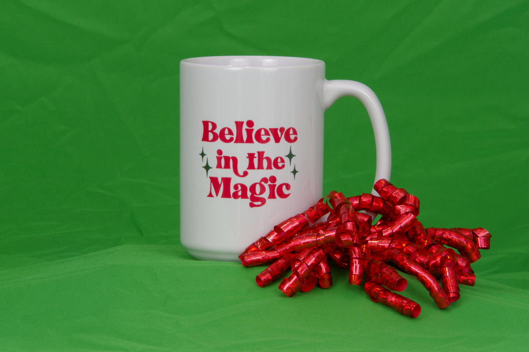 White mug with words Believe in the Magic in red. A cute mug for the Christmas season.