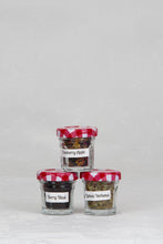 Load image into Gallery viewer, Three small jars with red and white checked lids, containing loose herbal fruit teas of Berry Blast, Cranberry Apple, and Lemon Verbena.  This one option of the mini tea tree set.
