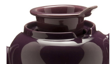 Load image into Gallery viewer, Tea pot shown close up from the side to show off the built in loose leaf tea strainer. This tea pot is in the colour plum.
