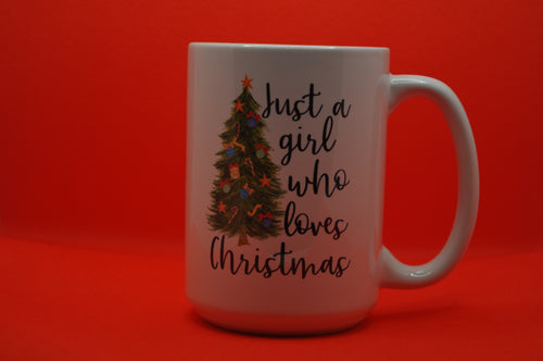 large white mug with a green, decorated Christmas tree with the words: Just a girl who loves Christmas in black writing. Great mug for tea.